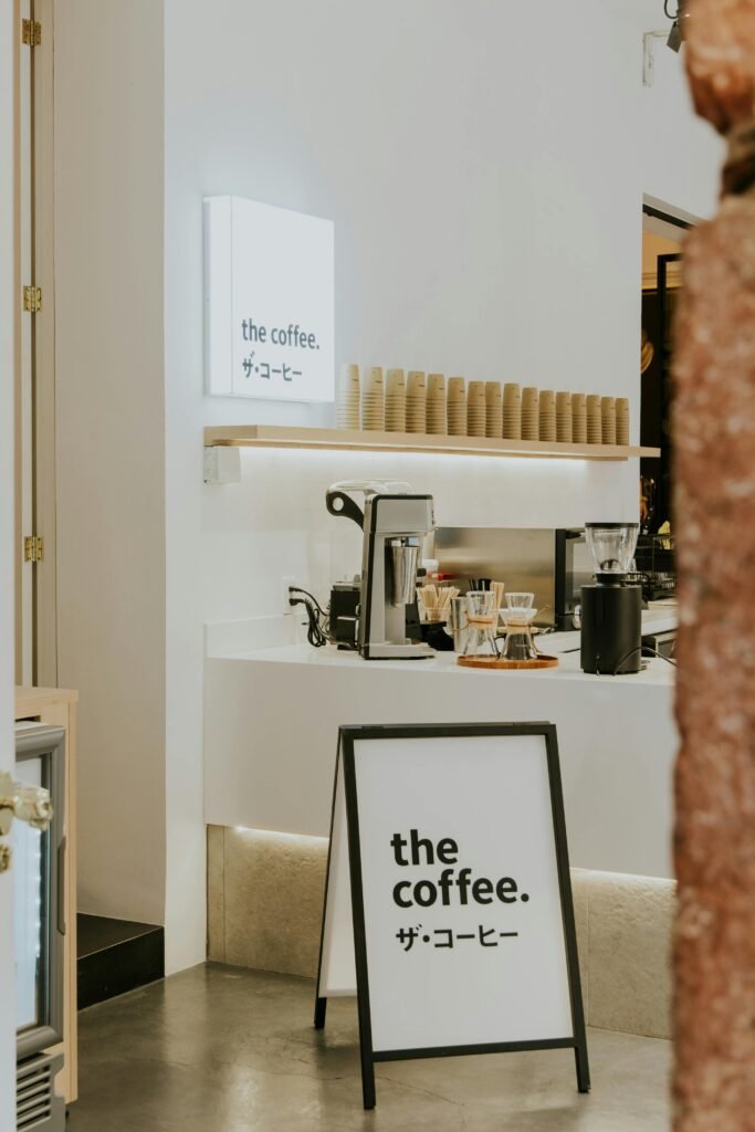 Explore a sleek and minimalist café interior with a focus on coffee preparation and design.